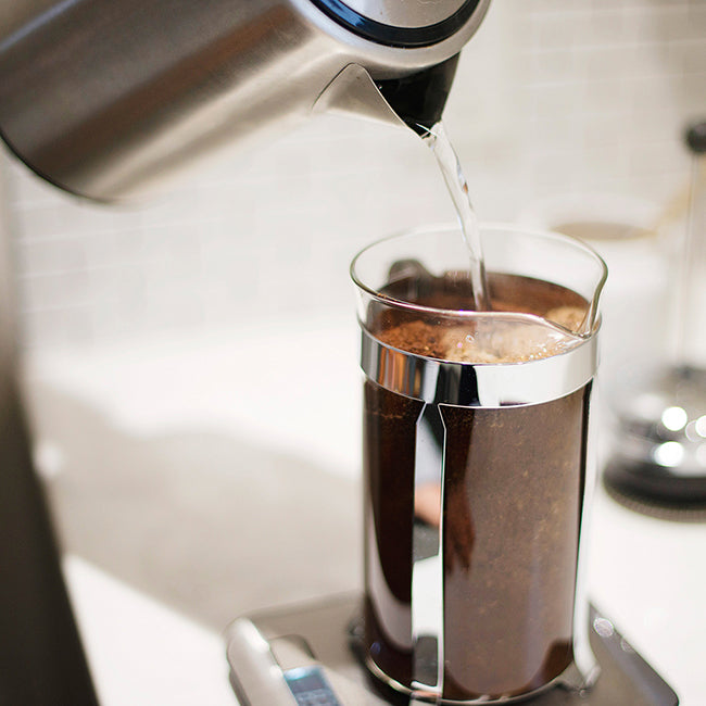 Water poured from kettle into french press on scale