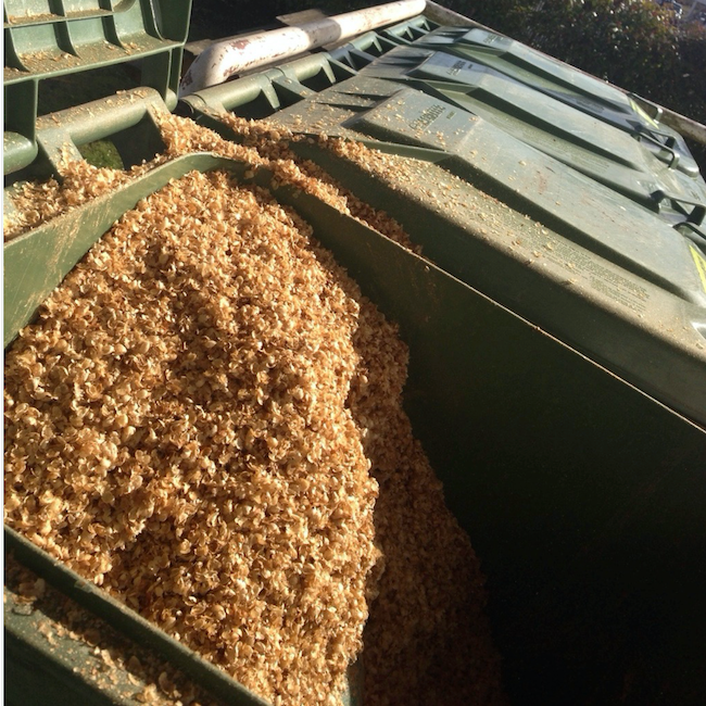 Coffee chaff in green composting bins